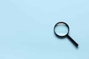 a magnifying glass on a sky blue background