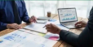 two business administrators sitting at a table analysing business and financial data