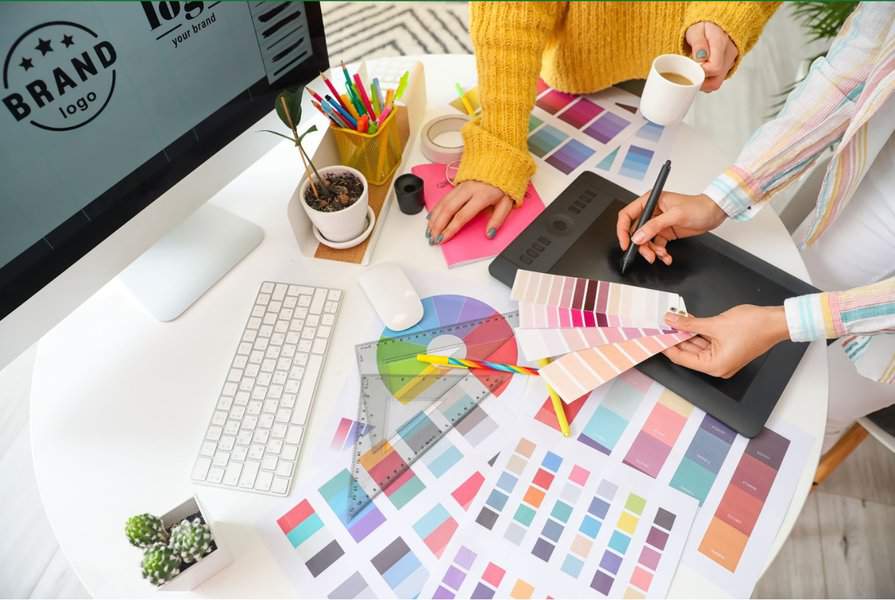 graphic designer with colleague in an office looking at colour charts