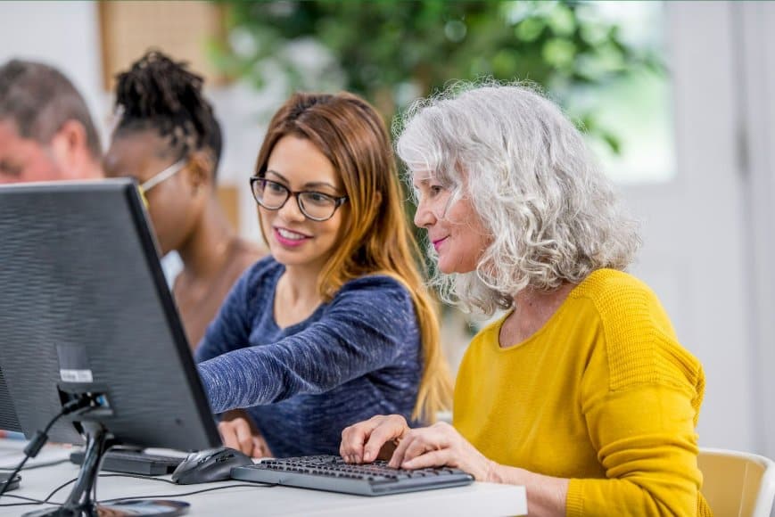 An older woman learning at an adult education centre.